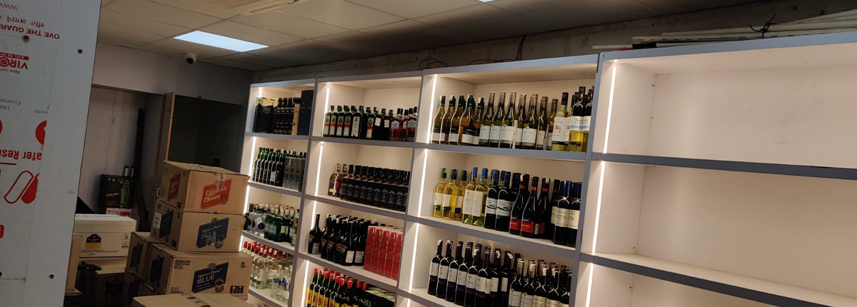 Liquor store wall rack with LED lighting by Baba SuperSign